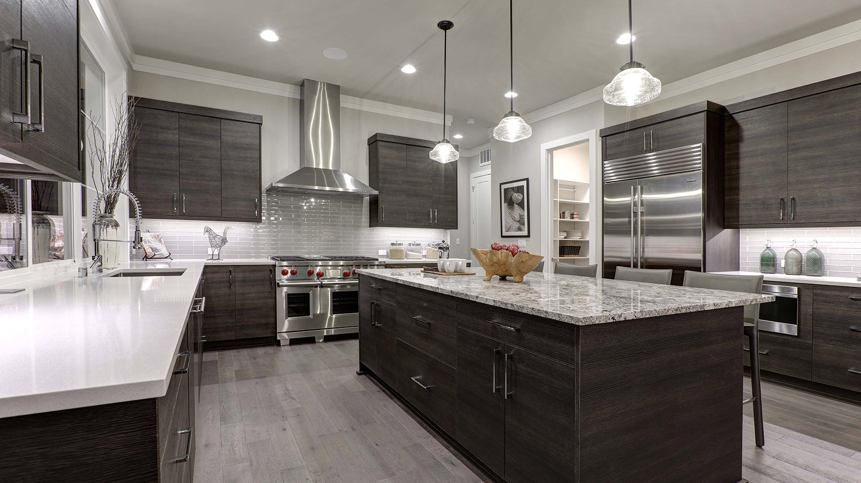 Modern gray kitchen features dark gray flat front cabinets paire